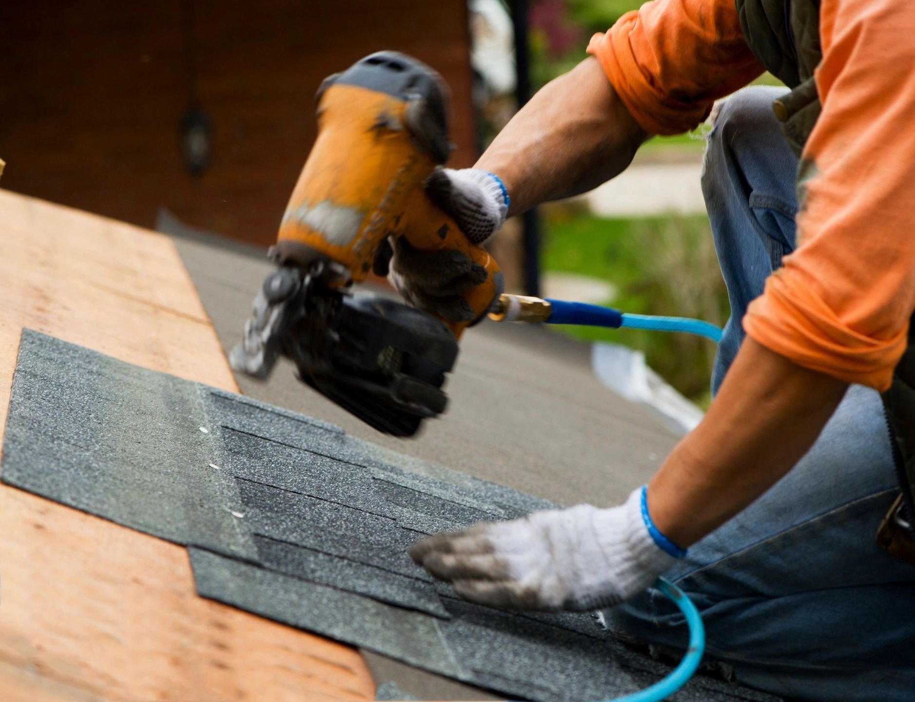Roofer repairing shingles