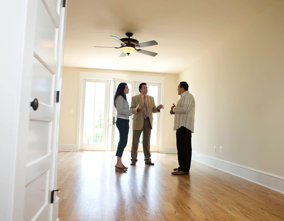 Real estate agent showing home to couple